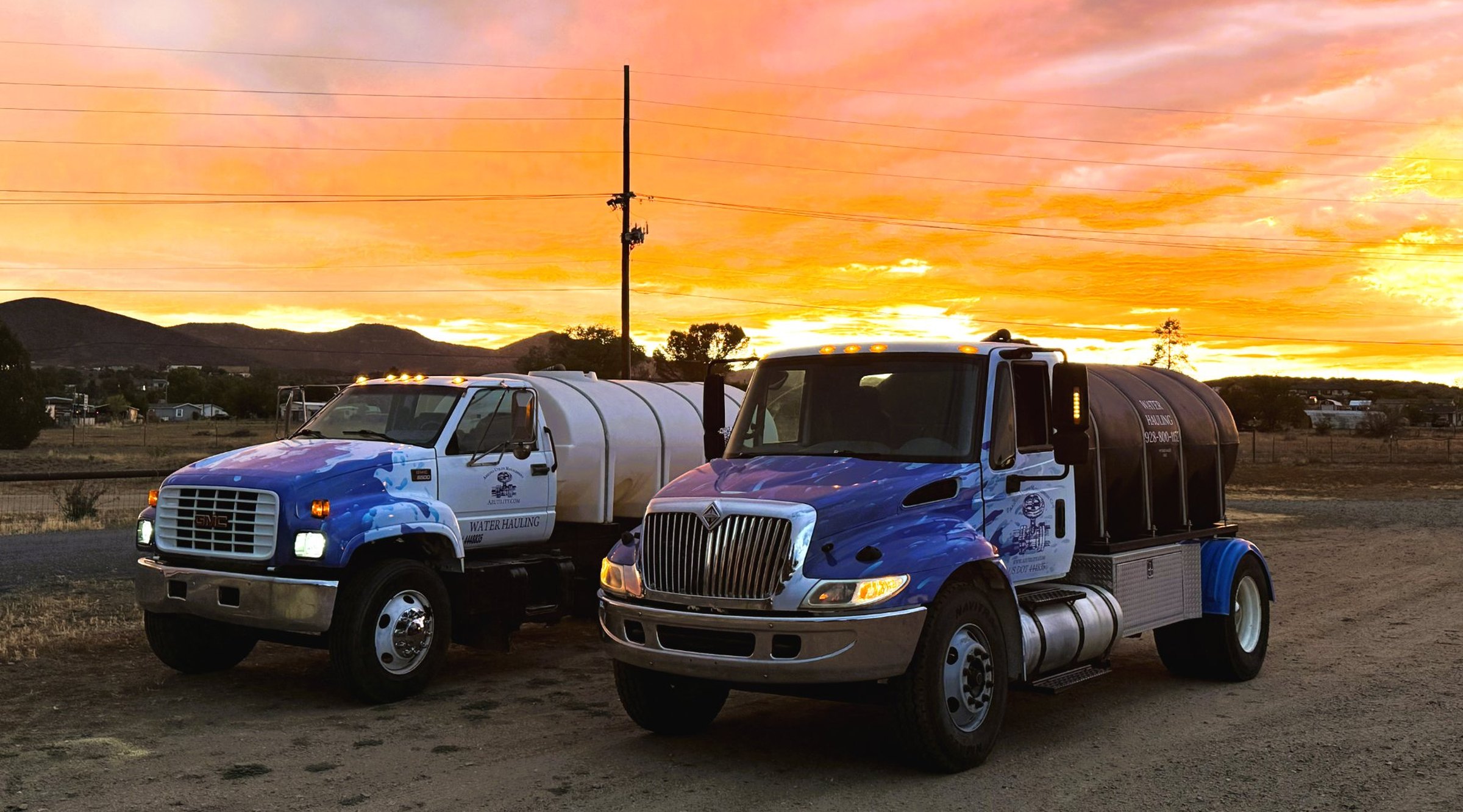 Two Arizona Utility Management water hauling trucks parked at sunset